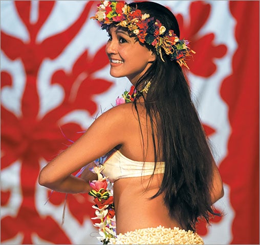 Native Polynesian woman performing a dance in front of a Taifaifai.