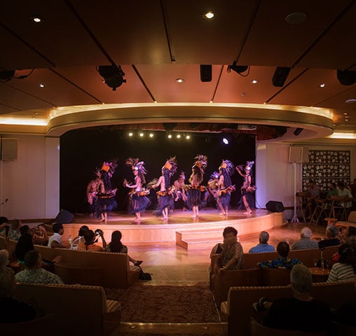 A Polynesian dance troupe performing for guests aboard the m/s Paul Gauguin.
