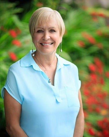 A portrait photo of Sandy Stevens, Vice President of Sales at the South Pacific small cruise line, Paul Gauguin Cruises.