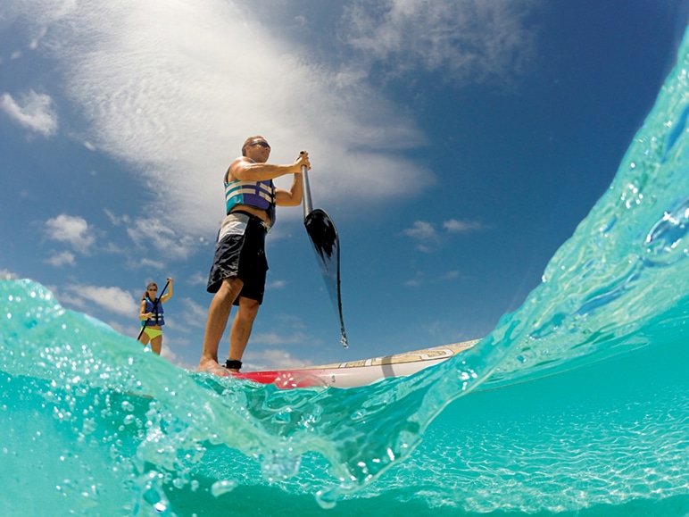 man paddleboarding blue lagoon