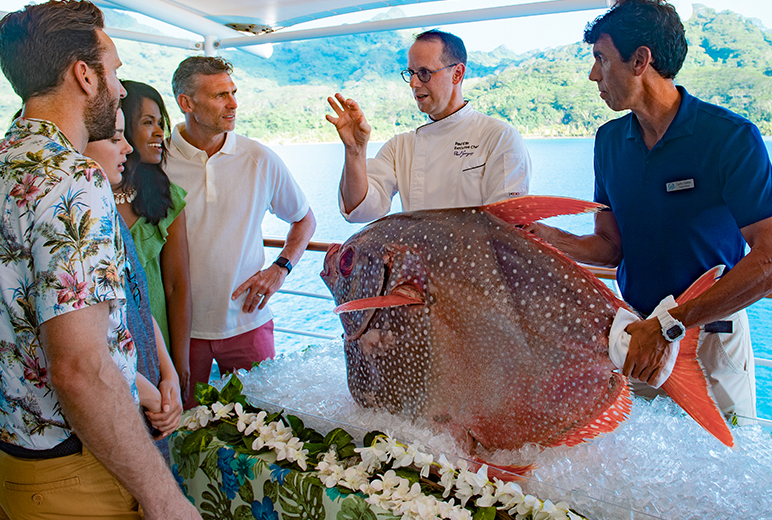 The Gauguin’s Executive Chef Paul Ellis hosts a moon fish filet presentation