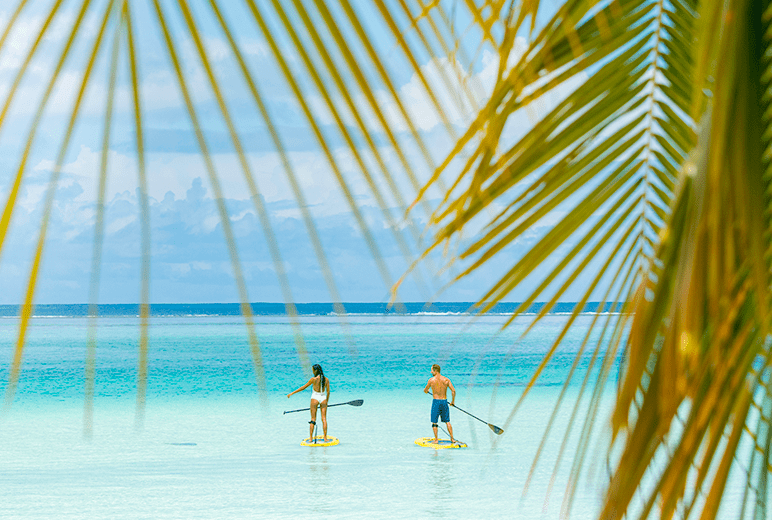 couple paddle-boarding in Tahiti